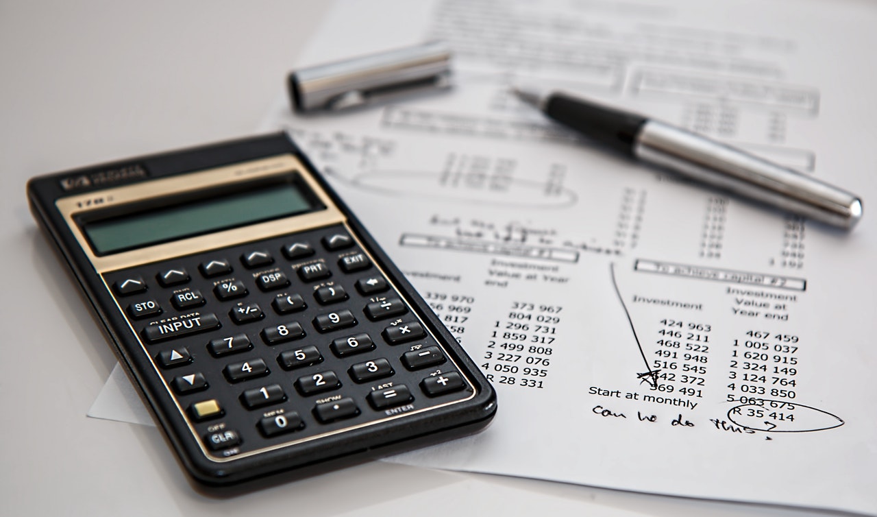 Image of a calculator and a sheet with investment details with a handwritten comment asking: Can we do this?